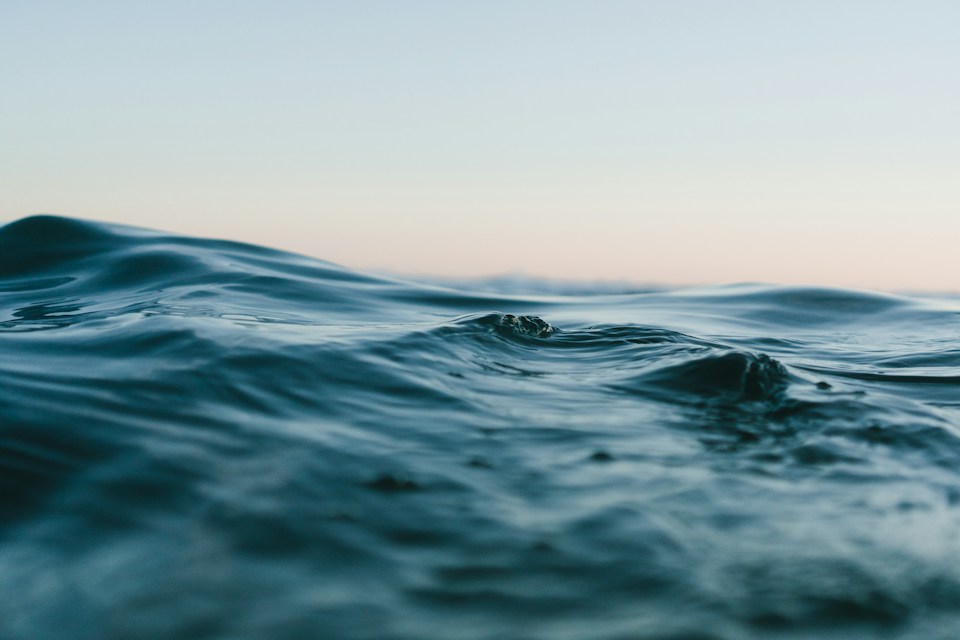 Soft blue ocean waves in the afternoon light