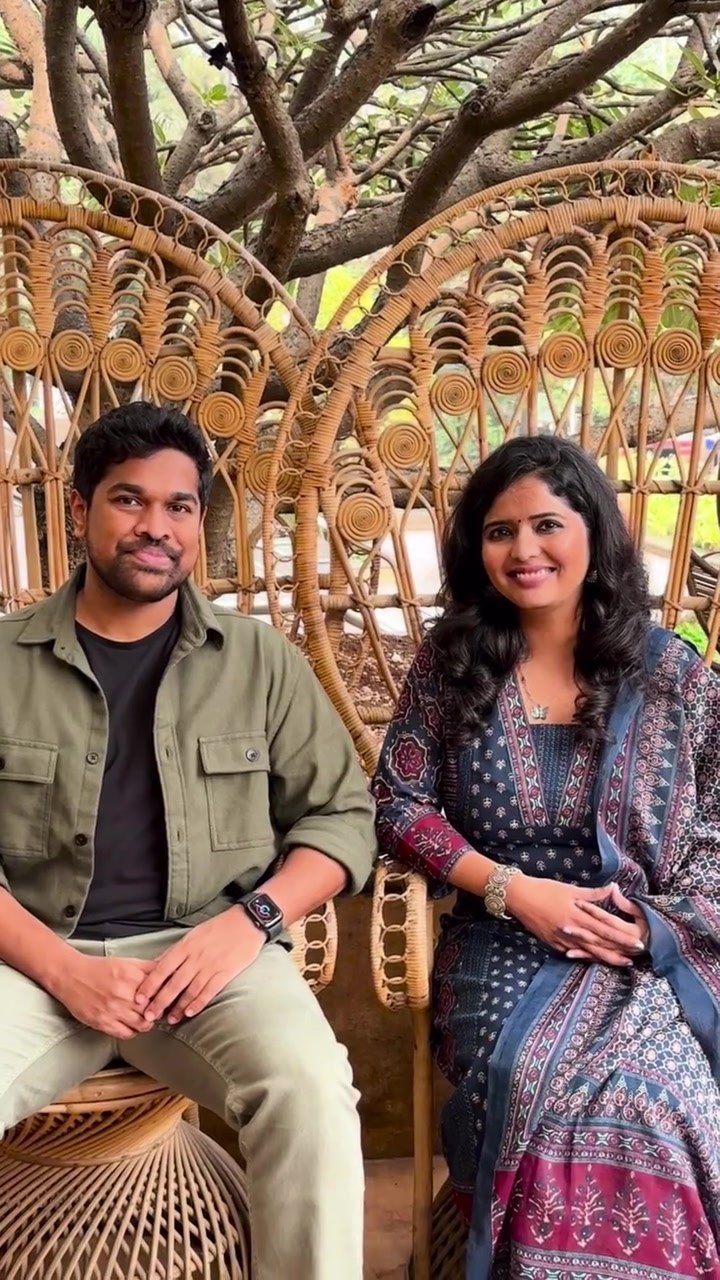 Soham and Sonam sitting together on a wicker swing